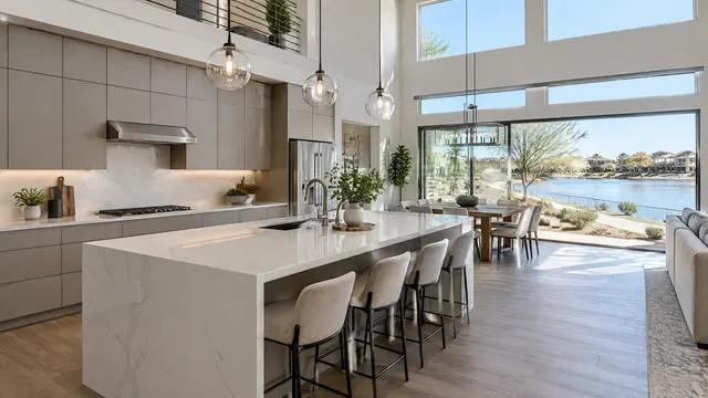 Modern kitchen in a two-story Fulton Ranch, Chandler home with flat-panel cabinets, a quartz island and a view of a lakeside walking path